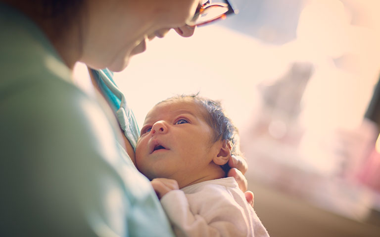 Woman smiling at baby