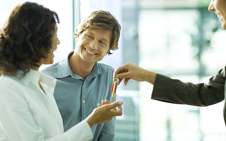 Happy couple receiving keys