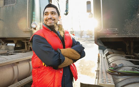 Man smiling next to a truck